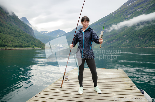 Image of Woman fishing on Fishing rod spinning in Norway.