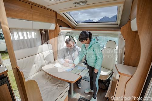 Image of Couples in RV Camper looking at the local map for the trip.