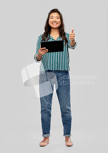 Image of happy asian woman with tablet pc showing thumbs up