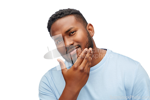 Image of happy african american man touching his beard