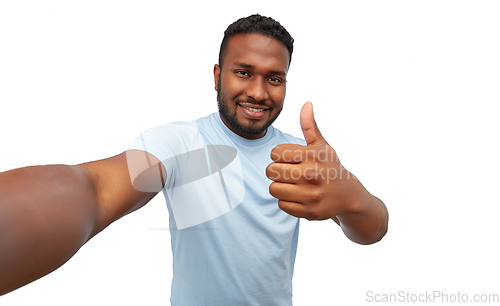 Image of smiling young african american man taking selfie