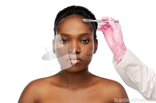 Image of face of african american woman and scalpel knife