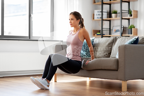 Image of young woman exercising at home