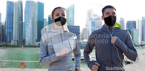 Image of couple in masks jogging in singapore