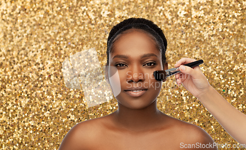 Image of african woman and hand with make up brush