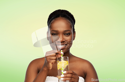 Image of african american woman with glass of fruit water