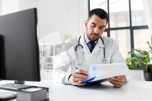 Image of male doctor with clipboard at hospital