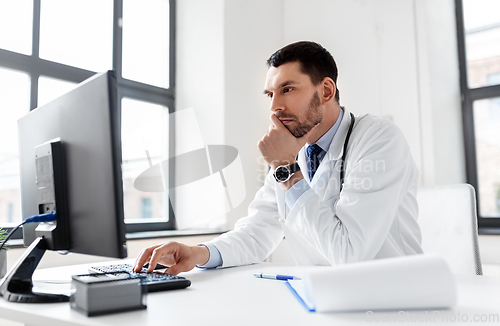 Image of male doctor with computer working at hospital