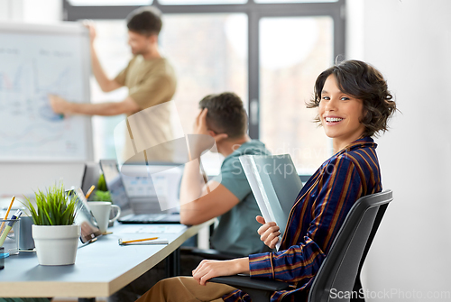 Image of smiling businesswoman at office conference