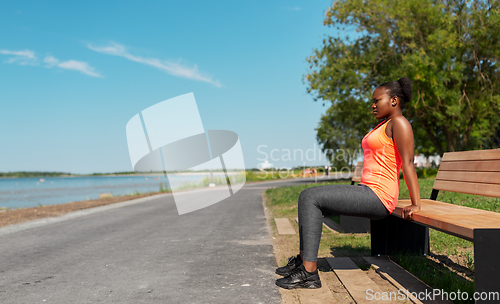 Image of african american woman doing sports at seaside