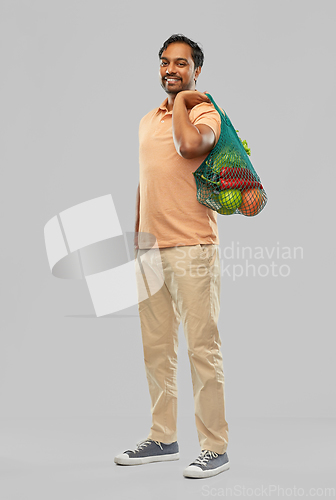 Image of happy indian man with food in reusable net tote