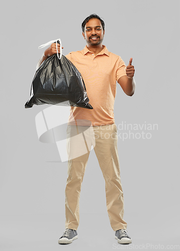 Image of happy indian man with trash bag showing thumbs up