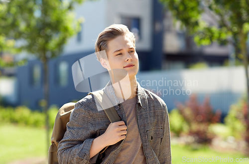 Image of teenage student boy with backpack in city