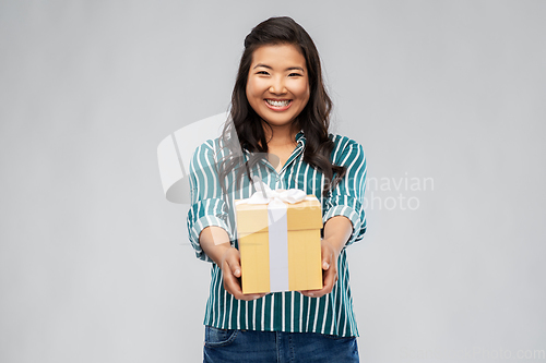 Image of happy asian woman with birthday present