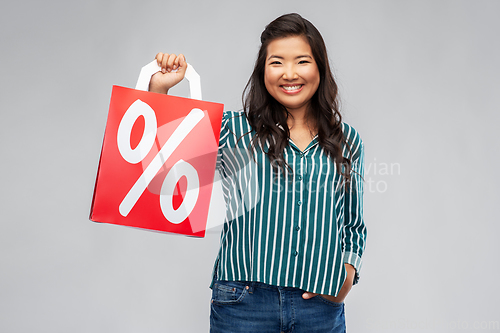 Image of asian woman with percentage sign on shopping bags