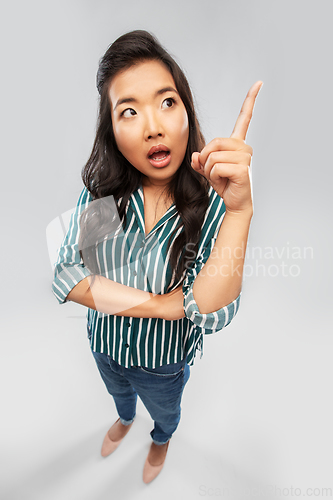 Image of asian woman pointing finger up