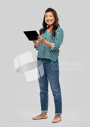 Image of happy asian woman using tablet computer