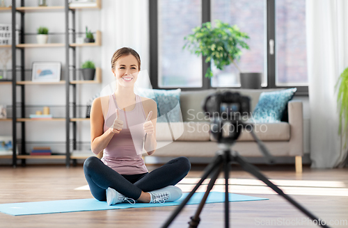 Image of woman or blogger recording training class at home
