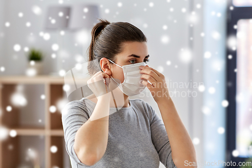 Image of young woman wearing protective medical mask