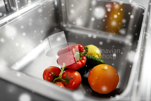 Image of fruits and vegetables in kitchen sink