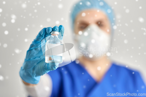 Image of close up of doctor's hand with bottle of medicine