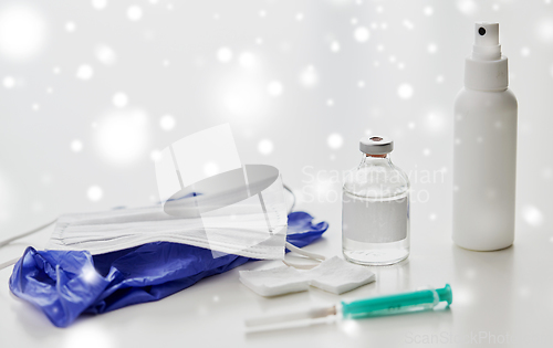 Image of syringe, medicine, wound wipes, gloves and mask