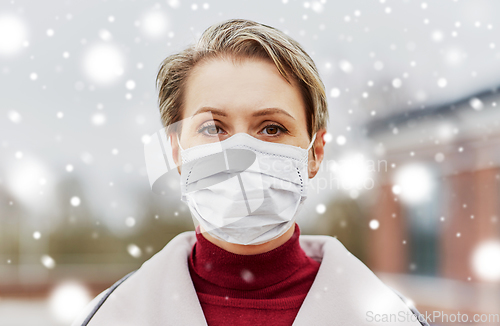 Image of young woman wearing protective medical mask