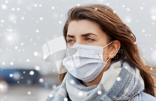 Image of young woman wearing protective medical mask