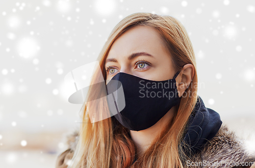 Image of woman wearing protective reusable barrier mask