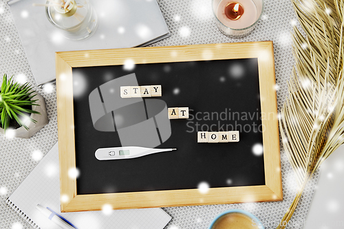 Image of chalkboard with stay at home words on toy blocks