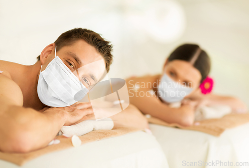 Image of couple in masks at spa