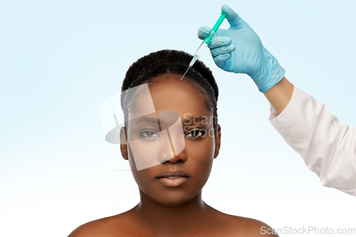 Image of african woman and hand in glove with syringe