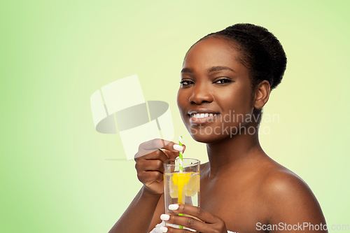 Image of african american woman with glass of fruit water