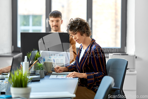 Image of creative woman working on user interface at office