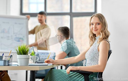 Image of smiling businesswoman at office conference