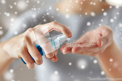 Image of close up of woman spraying hand sanitizer