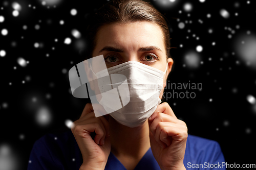 Image of female doctor or nurse in medical face mask