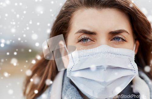 Image of young woman wearing protective medical mask