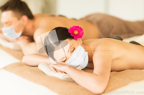 Image of couple in masks at spa