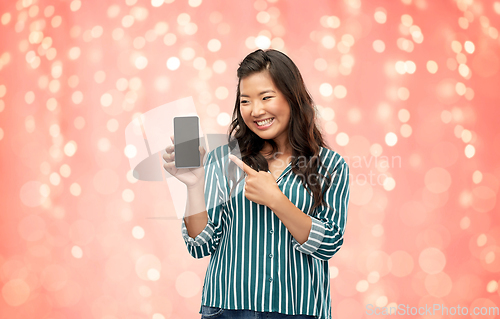 Image of happy asian woman over grey background