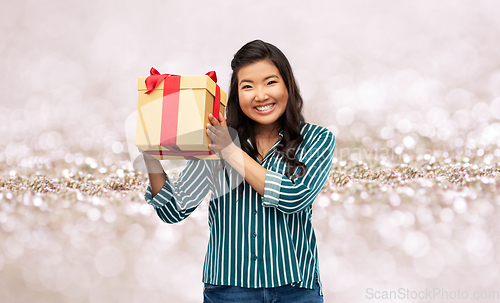 Image of happy asian woman with birthday present