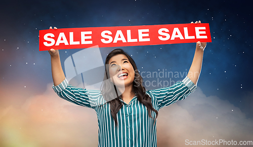 Image of happy smiling young asian woman with sale banner