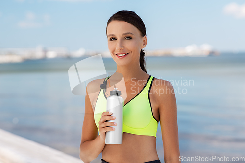 Image of woman drinking water from bottle after sports