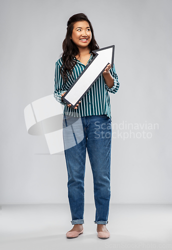 Image of happy smiling asian woman with arrow pointing up