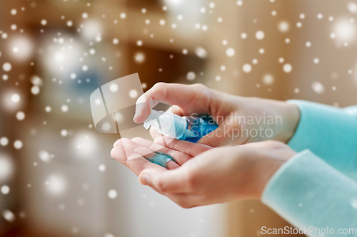 Image of close up of woman spraying hand sanitizer