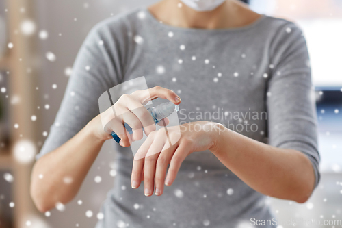 Image of close up of woman spraying hand sanitizer