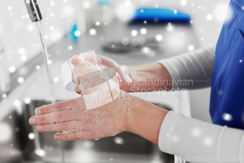 Image of doctor or nurse washing hands with liquid soap