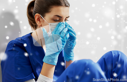 Image of sad doctor or nurse in protective face mask