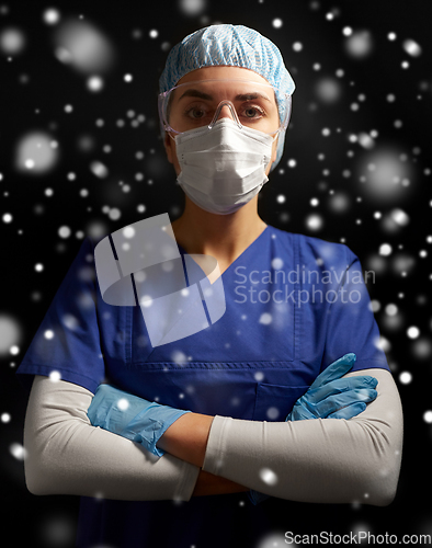 Image of female doctor or nurse in goggles and face mask