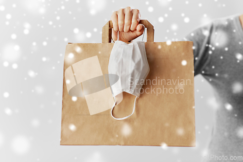 Image of woman with shopping bag and face protective mask